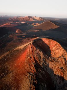 an aerial view of the desert with mountains in the background