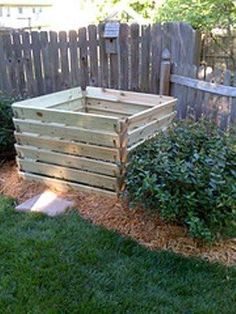 a wooden planter sitting in the middle of a yard