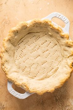 an uncooked pie crust sitting on top of a counter