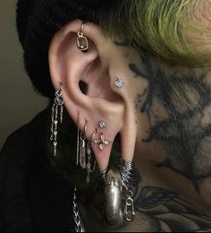 a man with tattoos and piercings on his ear