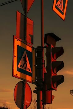 traffic lights and street signs are lit up at dusk