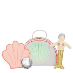 Inside this pretty suitcase, with a shimmering scallop shell design, is a special surprise! A beautiful mermaid, with a shiny gold tail, waiting to be played with. She comes with a soft quilt for her to snuggle up with for sweet dreams. Cotton doll with gold fabric tail. Pink cotton shell quilt & silver pillow. Shell case with cord handle & metal clasp. Neon & gold stitching with silver holographic foil detail. Pack dimensions: 6 x 4.5 x 2.125 inches Meri Meri Mermaid, Doll Suitcase, Mini Suitcase, Mermaid Party Supplies, Mermaid Toys, Soft Quilt, Mermaid Party Favors, Silver Pillows, Mermaid Party Decorations