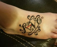 a woman's foot with a tattoo on it that reads love and has a clock in the middle