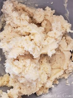 a bowl filled with white batter sitting on top of a table