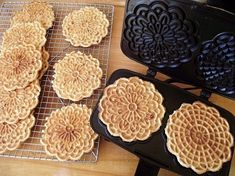 several waffles are cooling on a rack next to an electric griddle oven