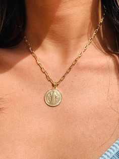 Embrace the divine protection and timeless style of our gold-filled St. Benedict charm necklace. This exquisite piece showcases a delicate paperclip chain adorned with a beautifully crafted St. Benedict charm in radiant gold. The St. Benedict medal symbolizes spiritual strength and serves as a powerful symbol of faith. With its intricate detailing and elegant design, this necklace is a perfect combination of fashion and spirituality. Wear it as a personal talisman or gift it to someone special. Gold Charm Necklaces With Initial Pendant And Paperclip Chain, Gold Charm Necklace With Initial Pendant And Paperclip Chain, Gold 14k Paperclip Chain Charm Necklace, Gold Plated Paperclip Chain Necklace, Gold Pendant Charm Necklaces With Paperclip Chain, Gold Pendant Charm Necklace With Paperclip Chain, Medallion Chain Necklace With Paperclip Chain As Gift, Gold Paperclip Chain Necklace With Round Pendant, Paperclip Chain Medallion Jewelry As Gift