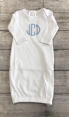 a white onesuit with the word jed on it and blue letters in front