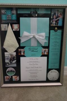 a wedding gift is displayed in a silver frame with white ribbon and pictures on it