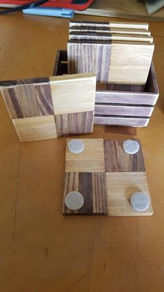 four pieces of wood sitting on top of a wooden table next to each other with holes in them