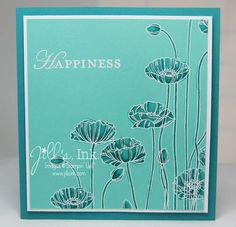 a blue card with white flowers and the words happiness written in cursive writing