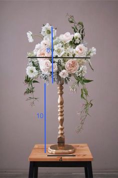 a tall wooden stand with flowers on it