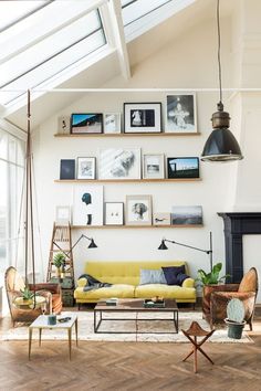 a living room filled with furniture and pictures on the wall