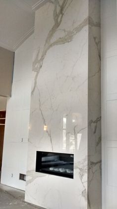 a large white marble fireplace in a room