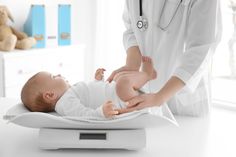 a baby is being examined by a doctor