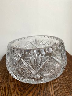 a glass bowl sitting on top of a wooden table