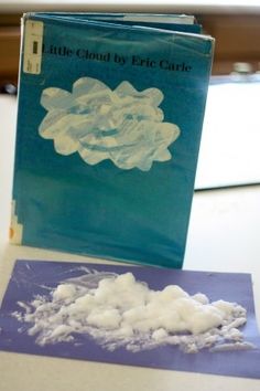 a book sitting on top of a table next to a pile of cotton