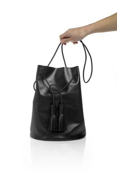 Black bucket bag with tassels Minimalist Bucket Bag For Everyday Use, Minimalist Bucket Bag For Everyday, Minimalist Everyday Bucket Bag, Chic Daily Use Bucket Bag With Tassels, Chic Bucket Shoulder Bag With Tassels, Daily Use Crossbody Bucket Bag With Tassels, Daily Crossbody Bucket Bag With Tassels, Crossbody Bucket Bag With Tassels For Travel, Travel Crossbody Bucket Bag With Tassels