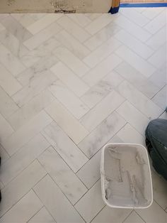 a bathroom floor that is being remodeled with white tile