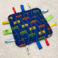 a blue pot holder with cars on it and toothbrushes sticking out of the top