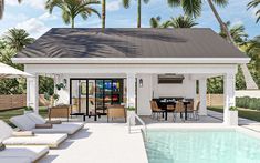 a pool house with an outdoor dining area next to it and palm trees in the background