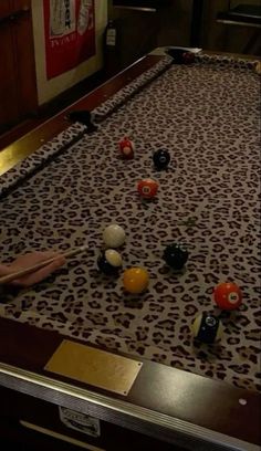 a pool table with balls and cues on it