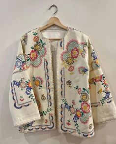 This is a comfortable women winter jackets made of pure cotton with a perfect combination of handmade retro flower embroidery Breathable pure cotton material, very comfortable to wear, we don't offer many sizes because it is very loose. This is an adult unisex long sleeved jackets. The pattern of handmade embroidery.  Please turn inside out and wash in cold water with a mild detergent. Do not use bleach. Tumble dry low or dry flat, if possible. Iron on low heat, if needed. Do not use steam. Embroidery Jacket, Embroidery Cotton, Handmade Embroidery, Retro Women, Winter Jackets Women, Flower Embroidery, Retro Flowers, Cotton Jacket, Embroidery Flowers