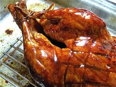 a roasting chicken is being cooked on a rack