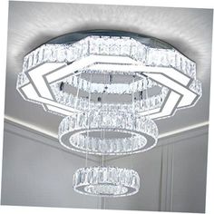 a large crystal chandelier hanging from the ceiling in a room with white walls