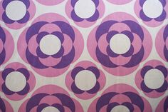 a pink and purple wallpaper with circles on it