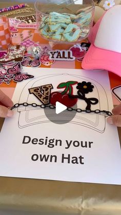 a person is holding up a sign that says design your own hat