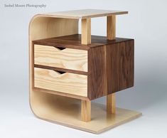 a small wooden table with two drawers on one side and an open drawer on the other