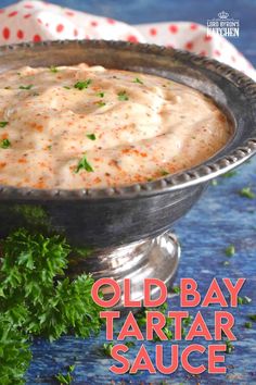 an old - bay tartar sauce in a silver bowl with parsley on the side