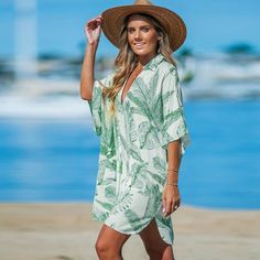 Add a touch of tropical charm to your look with our Green-and-White Palm Leaf Collared V-Neck Cover-Up. This breezy piece features a vibrant palm leaf print and flattering neckline, making it an essential addition to your beachwear collection. Product code: CAA07B4B025RC Green V-neck Swimwear For Beach Cover-up, Green Printed V-neck Cover-up, Green Tropical Print Spring Cover-up, Green Tropical Printed Cover-up, Summer Palm Tree Print Swimwear Cover-up, Beachwear Collection, Palm Leaves Print, Palm Leaves, Cover Up Dress