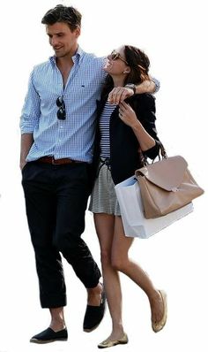 a man and woman walking down the street with bags on their backs, both carrying shopping bags