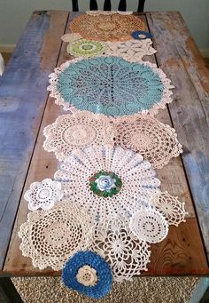 the table is made out of wood and has crocheted doily on it