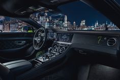 the interior of a mercedes s - class coupe with city lights in the background at night