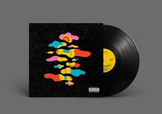 a black vinyl record with colorful artwork on it