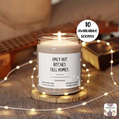 a candle sitting on top of a table next to a string of lights and a guitar