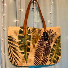 New Its Got A Beautiful Design With Oversized Palm Tree Leaves, Still In Original Packaging Great For Your Upcoming Vacation Can Fit Your Wallet, Selfie Stick, Or Camera, Sun Tan Lotions Like Everything You Need It Can Fit A Towel, Sandals Its Light To Carry And Very Durable Faux Leather Straps It Has An 11" Strap Drop 19"Wx13"H Very Roomy! Tan Shoulder Bag For Summer Vacation, Tan Shoulder Bag For Summer Beach Outings, Tan Shoulder Bag For Summer Beach, Tan Straw Bag With Braided Handles For Beach, Tan Woven Bags For Vacation, Tan Tote Beach Bag, Summer Vacation Tan Straw Bag, Tan Straw Tote Bag For Vacation, Tan Beach Bags With Braided Handles