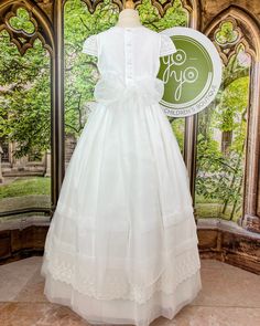 An adorable and romantic, yet classical communion gown for girls made with a lightweight optic white organza and embroidered laces. It has delicate pleats throughout and lace details on the sleeves, skirt, and body of the dress. This dress has buttons and a bow on the back for closure. True to size Lining: 100% cotton Dry clean Made in Spain Final Sale, no exchanges nor returns are available Size chart is in centimeters Claudia Dress, First Communion Dress, Spanish Fashion, Gowns For Girls, Communion Dresses, Children's Boutique, Dress 16, First Communion, Embroidered Lace