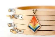 four wooden bracelets with beaded designs on them