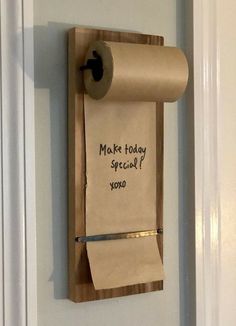 a roll of toilet paper hanging on the wall next to a sign that says make today special