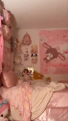 a pink bedroom with stuffed animals on the wall