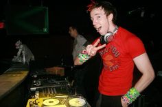 a man standing in front of a dj mixing equipment