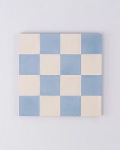 a blue and white checkered tile on a wall