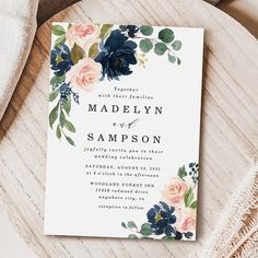 an elegant floral wedding card with navy blue and peach flowers