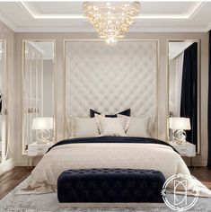 a large white bed sitting under a chandelier in a bedroom