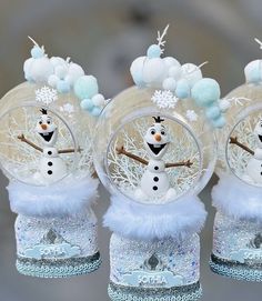 three snow globes with frosty decorations on them