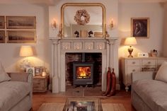 a living room filled with furniture and a fire place next to a mirror on the wall