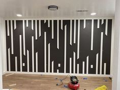 the room is being painted with black and white lines on it, while tools are scattered around